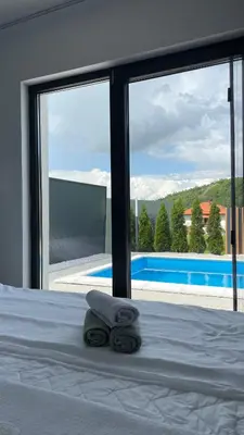 a bedroom with a bed with a view of a pool at Apartments B&M in Visoko