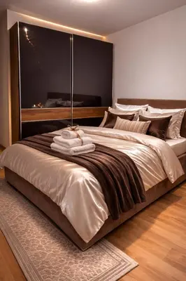 a bedroom with a large bed with a large window at Loft Lux in Banja Luka