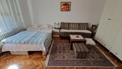 a living room with a bed and a couch at TUZLA ViVa 2 in Tuzla
