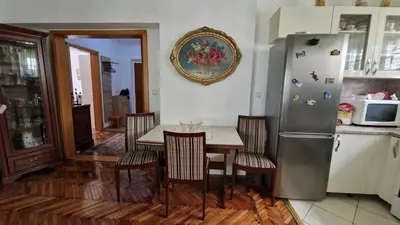 a kitchen with a table and a refrigerator at TUZLA ViVa 2 in Tuzla