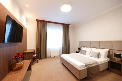 a hotel room with a bed and a television at Hotel Vidović in Banja Luka