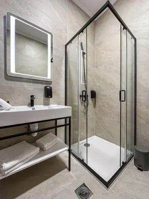 a bathroom with a shower and a sink at Hotel Vidović in Banja Luka