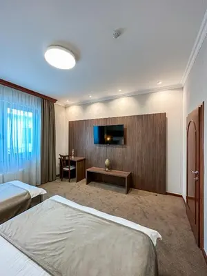 a hotel room with two beds and a flat screen tv at Hotel Vidović in Banja Luka