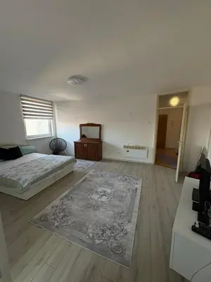 a bedroom with two beds and a rug on the floor at Apartment Lamele Bugojno in Bugojno