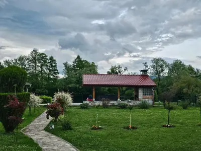 a garden with a pavilion in the middle of a field at Aventurin Superior Apartments in Bihać