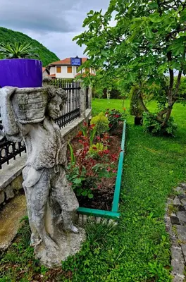 a statue of a bear carrying a pillow on a bench at Aventurin Superior Apartments in Bihać