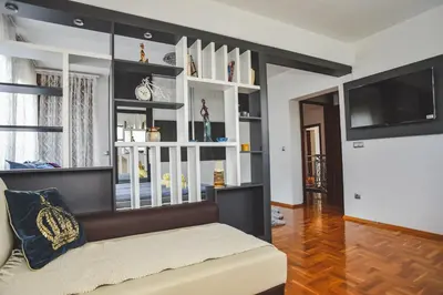 a living room with a couch and a flat screen tv at Aventurin Superior Apartments in Bihać