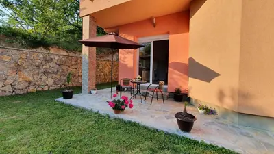 a patio with an umbrella and a table and chairs at Villa Panorama in Bihać