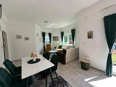 a living room with a table and a couch at Villa Panorama in Bihać