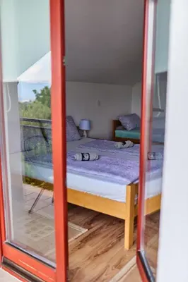 a view of a bed through a mirror at Guest house Al Meri in Travnik