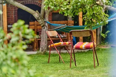 two chairs and a hammock in a yard at Guest house Al Meri in Travnik
