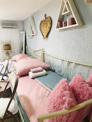 a bedroom with two twin beds with pink pillows at Apartman Indira in Visoko