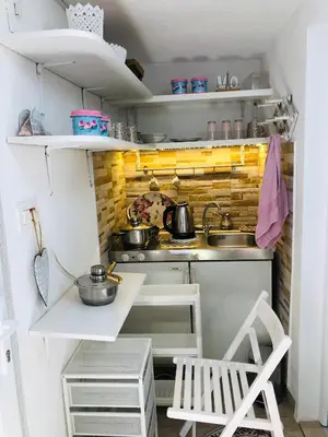 a small kitchen with a sink and a stove at Apartman Indira in Visoko