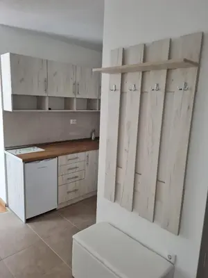 a kitchen with white cabinets and a white stove at Apartman Mirabell, Doboj in Doboj