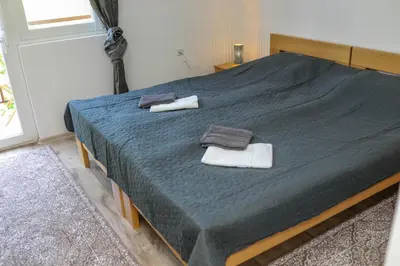 a bedroom with a large bed with towels on it at Aparthouse Bilic in Jajce