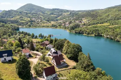 an aerial view of a lake with houses and trees at Aparthouse Bilic in Jajce