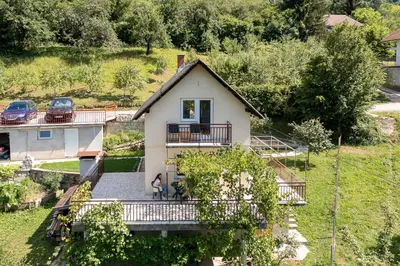 a small house with a dog on a balcony at Aparthouse Bilic in Jajce