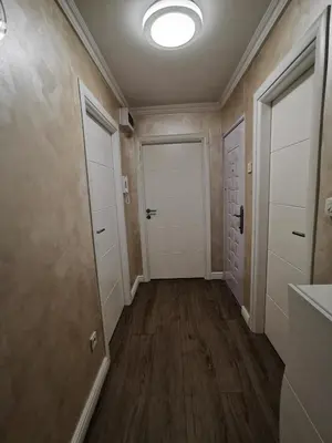 an empty hallway with two doors and a hallway at Lux Apartment with Sauna & Balcony in Banja Luka
