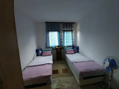 a room with two beds and a fan and a window at MIMA in Jajce