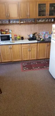 a kitchen with wooden cabinets and a white refrigerator at MIMA in Jajce