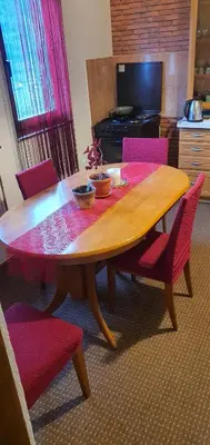a wooden table with red chairs and a dining room at MIMA in Jajce