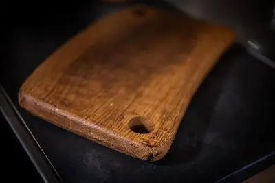 a wooden cutting board sitting on top of a stove at Stone room-Kamena soba in Šipovo