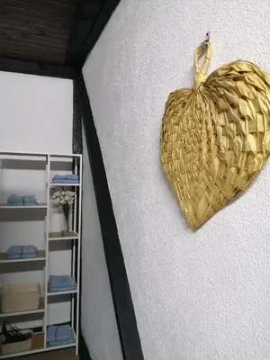 a gold heart hanging on a wall next to a shelf at Studio Apartman Sun in Jajce