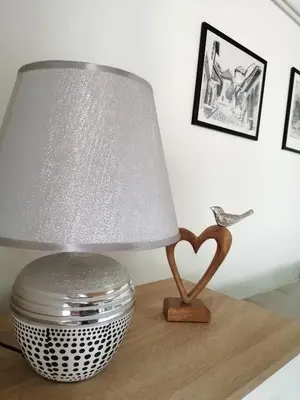 a table with a lamp and a heart on it at Studio Apartman Sun in Jajce