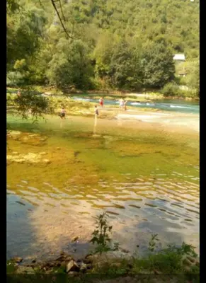 a group of people on a beach near a body of water at Apartmani Dada Kanjon Grmuša in Bihać