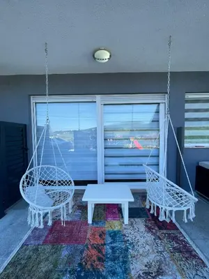 a living room with two swings and a table at Villa De Luxe in Bihać