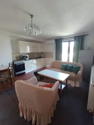 a living room with a couch and a table at Apartman 