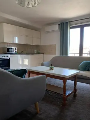 a living room with a couch and a coffee table at Apartman 