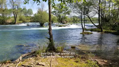 a river with rapids on the side of it at Apartman 