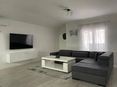 a living room with a couch and a tv at Apartman Kis in Jajce