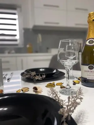 a table with a wine glass and a bottle of wine at Apartman Kis in Jajce