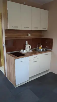 a kitchen with white cabinets and a sink at Apartmani Kakanj in Kakanj