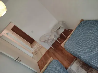 a room with a bed and a desk with a bedskirtspectspectspectspects at Apartman ALEM Bihac in Bihać