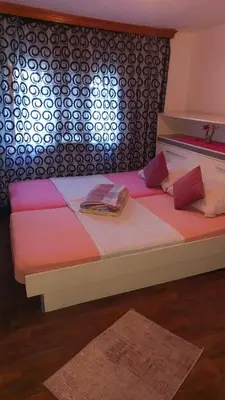 a bed with two pillows on it in a room at Family house in Visoko