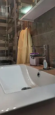 a bathroom with a sink and a mirror at Intime by Nights & Smiles in Tuzla