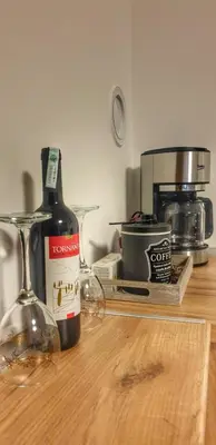 a bottle of wine sitting on top of a counter at Intime by Nights & Smiles in Tuzla