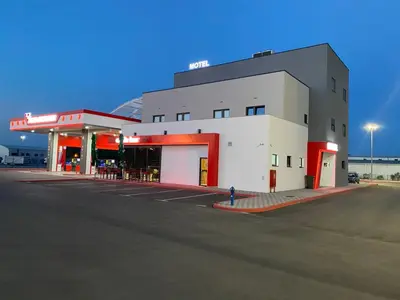 a gas station with a fire hydrant in a parking lot at Belamionix motel in Bosanski Šamac