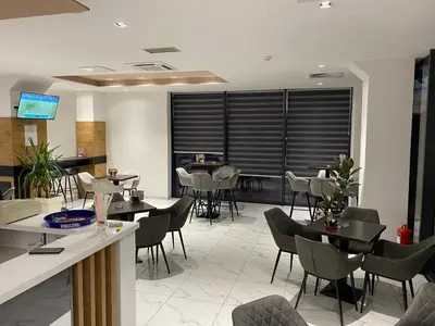 a restaurant with tables and chairs and a bar at Belamionix motel in Bosanski Šamac