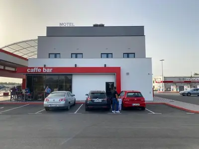 a car dealership with cars parked in a parking lot at Belamionix motel in Bosanski Šamac