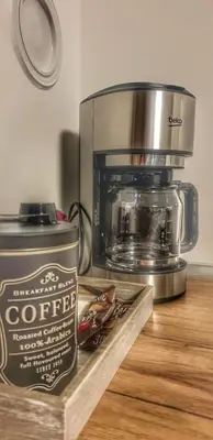 a coffee machine sitting on top of a wooden counter at Skyline by Nights & Smiles in Tuzla
