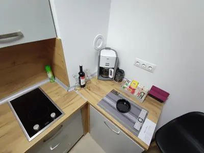 a small kitchen with a stove and a counter top at Identity By Nights & Smiles in Tuzla