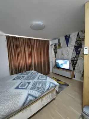 a bedroom with a bed and a flat screen tv at Identity By Nights & Smiles in Tuzla