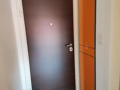 a brown door in a room with a cabinet at Apartment CITY in Doboj