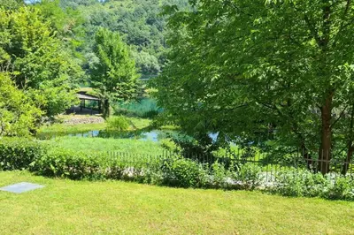 a garden with a pond and a gazebo at Villa DIAL Lohovo-dvoslap in Bihać