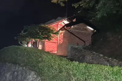 a red building with a light on it at night at Villa DIAL Lohovo-dvoslap in Bihać