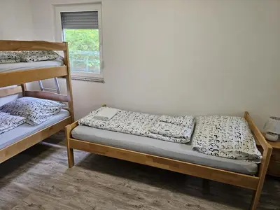 a room with two bunk beds and a window at Villa DIAL Lohovo-dvoslap in Bihać